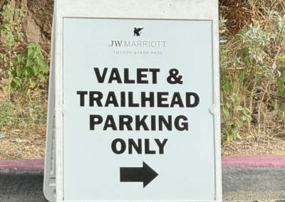 Image shows a sign directing drivers to the Starr Pass Resort valet and guest parking.