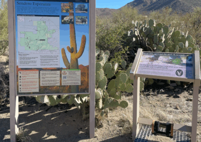 Image shows signs with a map and information for hikers.