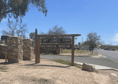 Image shows a wooden sign marking the main entrance to Fort Lowell Park from Craycroft Road.