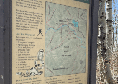 Image shows a sign for the Mt. Lemmon Trailhead with a map and hiking guidance.