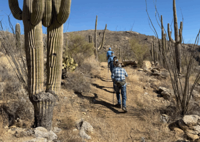 Image shows two hikers walking through steep sections of the trail.