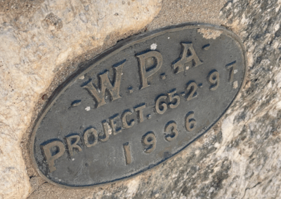 Image shows a metal plaque that honors the Work Administration Project in 1936.