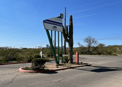 Image shows a tall sign and a saguaro marking the entry to Danny Lopez Park.