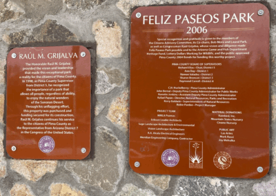 Image of plaques on the wall at the trailhead providing a history of the park's development.