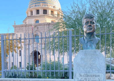 Image of a John F Kennedy bust in front of the Pima County Historic Courthouse.