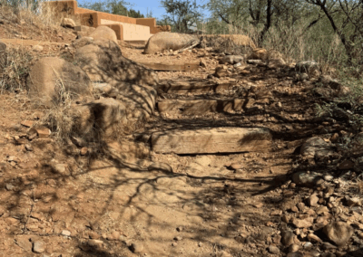 Image of a staircase of railroad ties climbing to an amphitheater near the trailhead.
